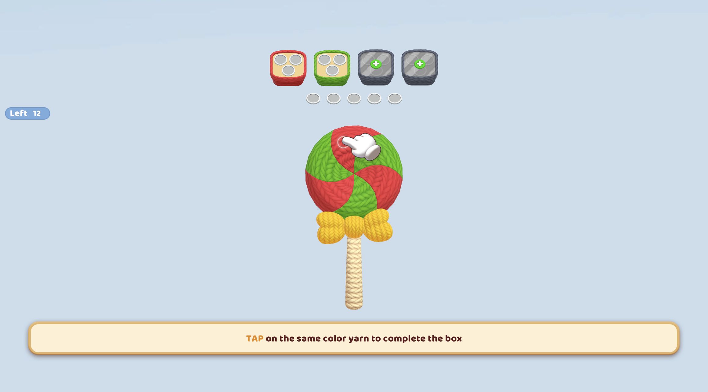 Yarn Fever first level with red and green three-slot boxes above a 12-piece knitted lollipop